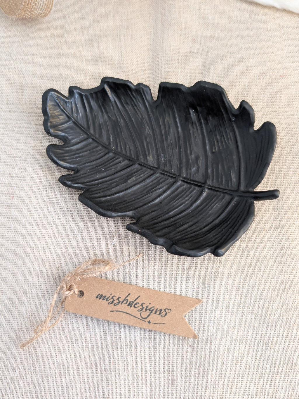 leaf shaped trinket tray made of eco resin jesmonite with a solid black finish handcrafted