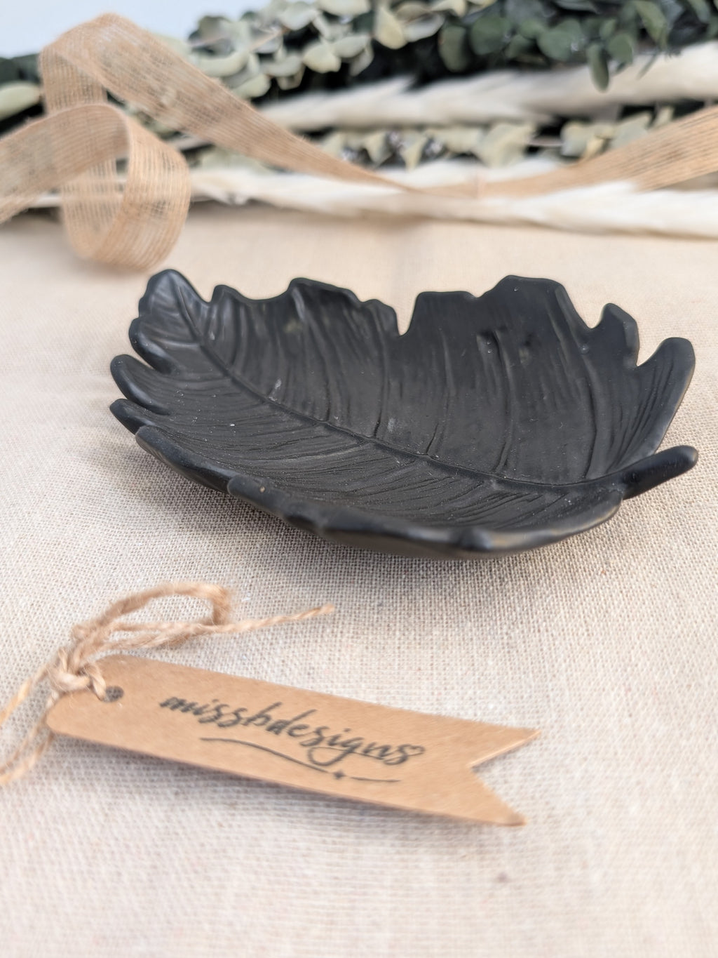 leaf shaped trinket tray made of eco resin jesmonite with a solid black finish handcrafted