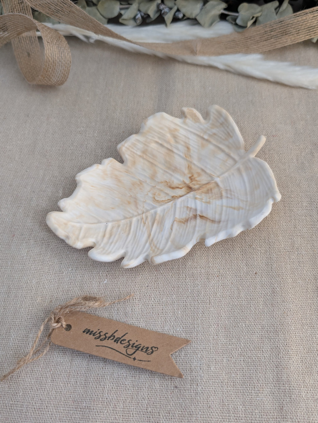 leaf shaped trinket tray made of eco resin jesmonite with a natural beige marble effect handcrafted