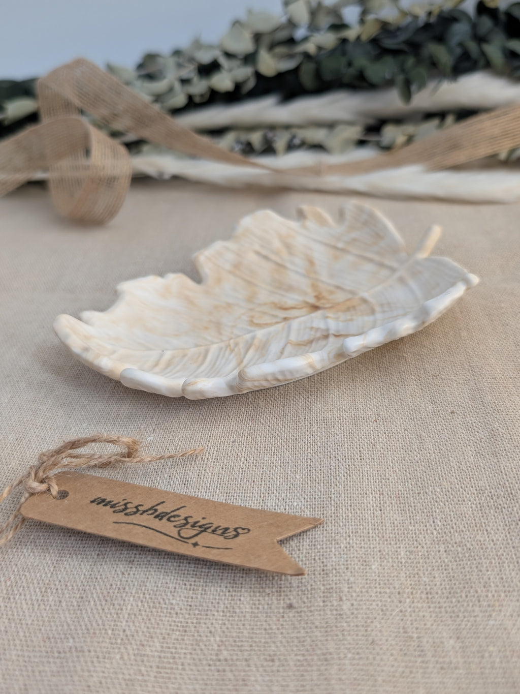 leaf shaped trinket tray made of eco resin jesmonite with a natural beige marble effect handcrafted