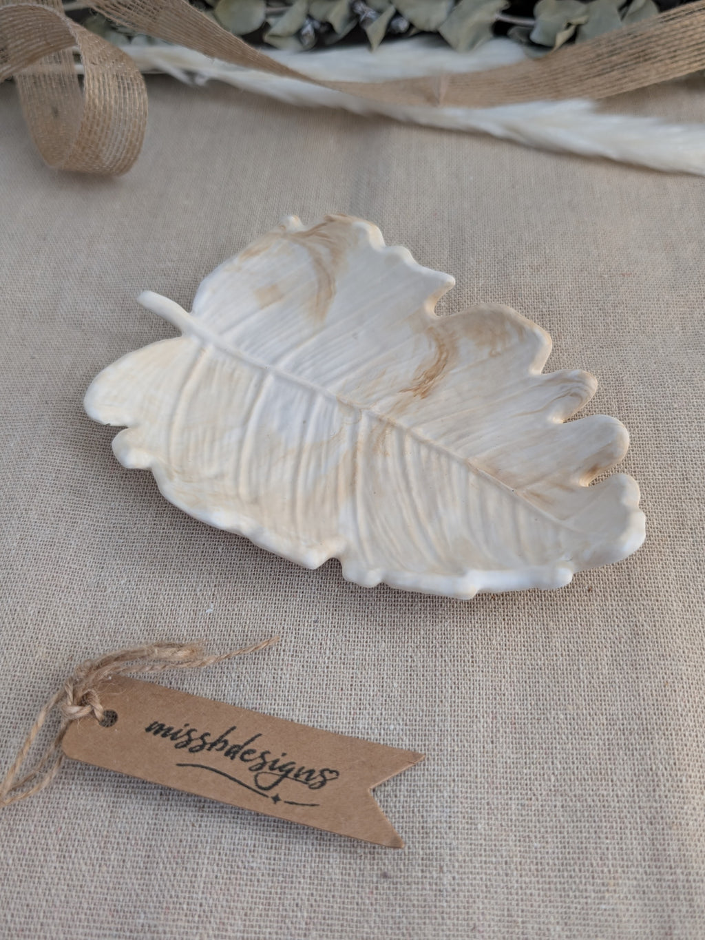 leaf shaped trinket tray made of eco resin jesmonite with a natural beige marble effect handcrafted