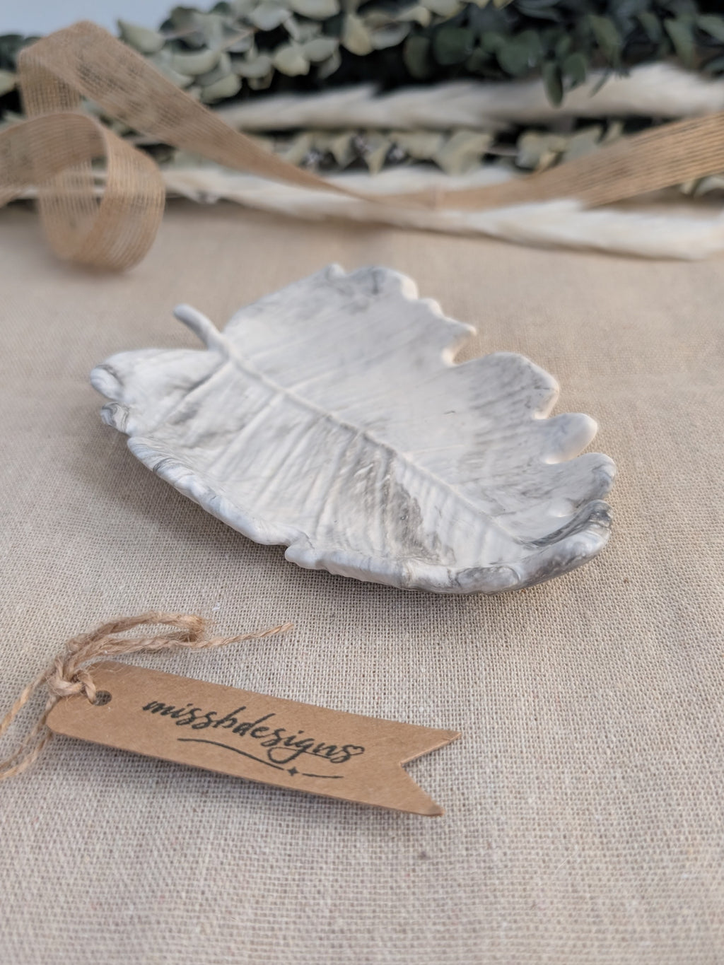 leaf shaped trinket tray made of eco resin jesmonite with a black grey marble effect handcrafted