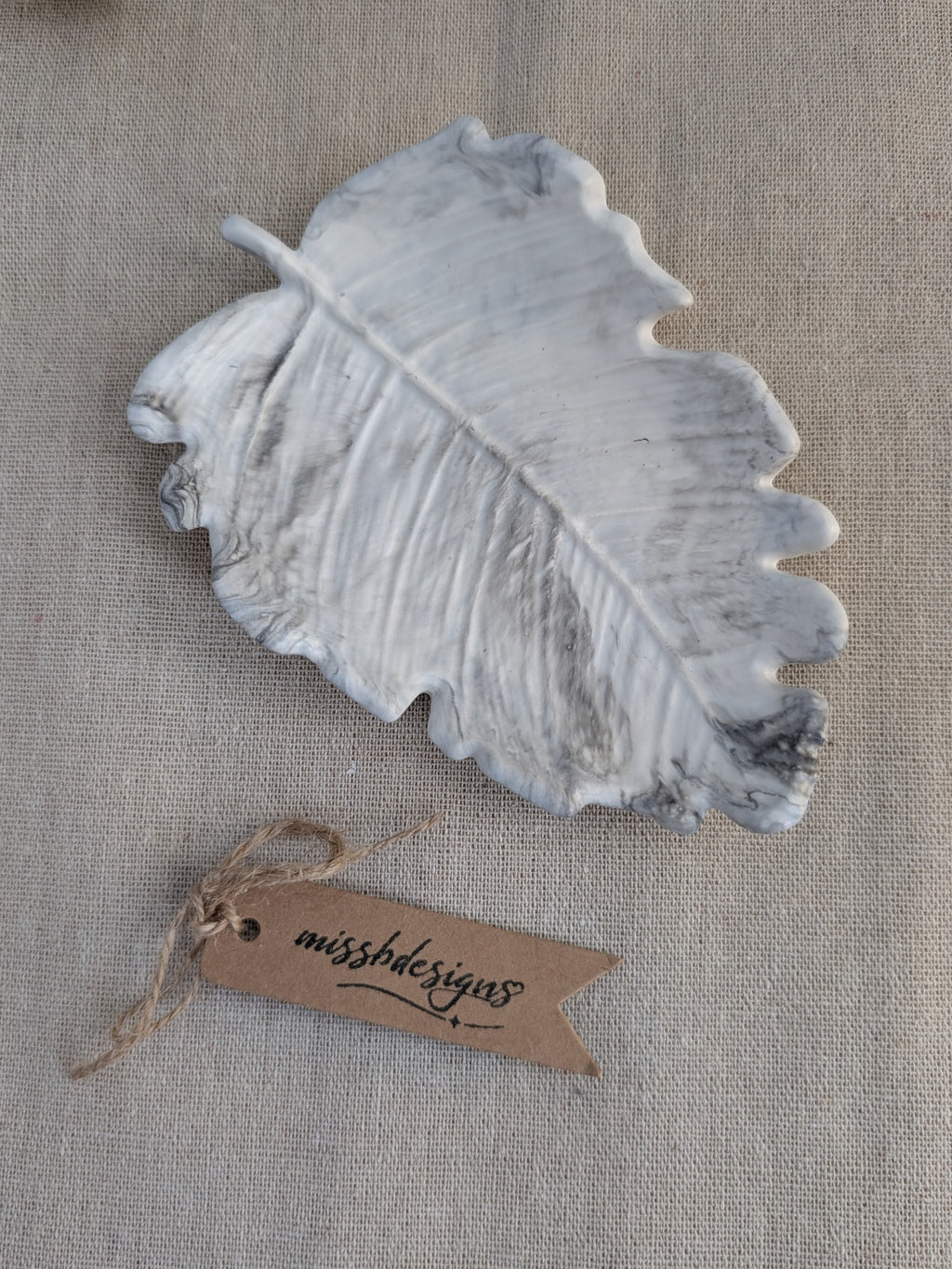 leaf shaped trinket tray made of eco resin jesmonite with a black grey marble effect handcrafted