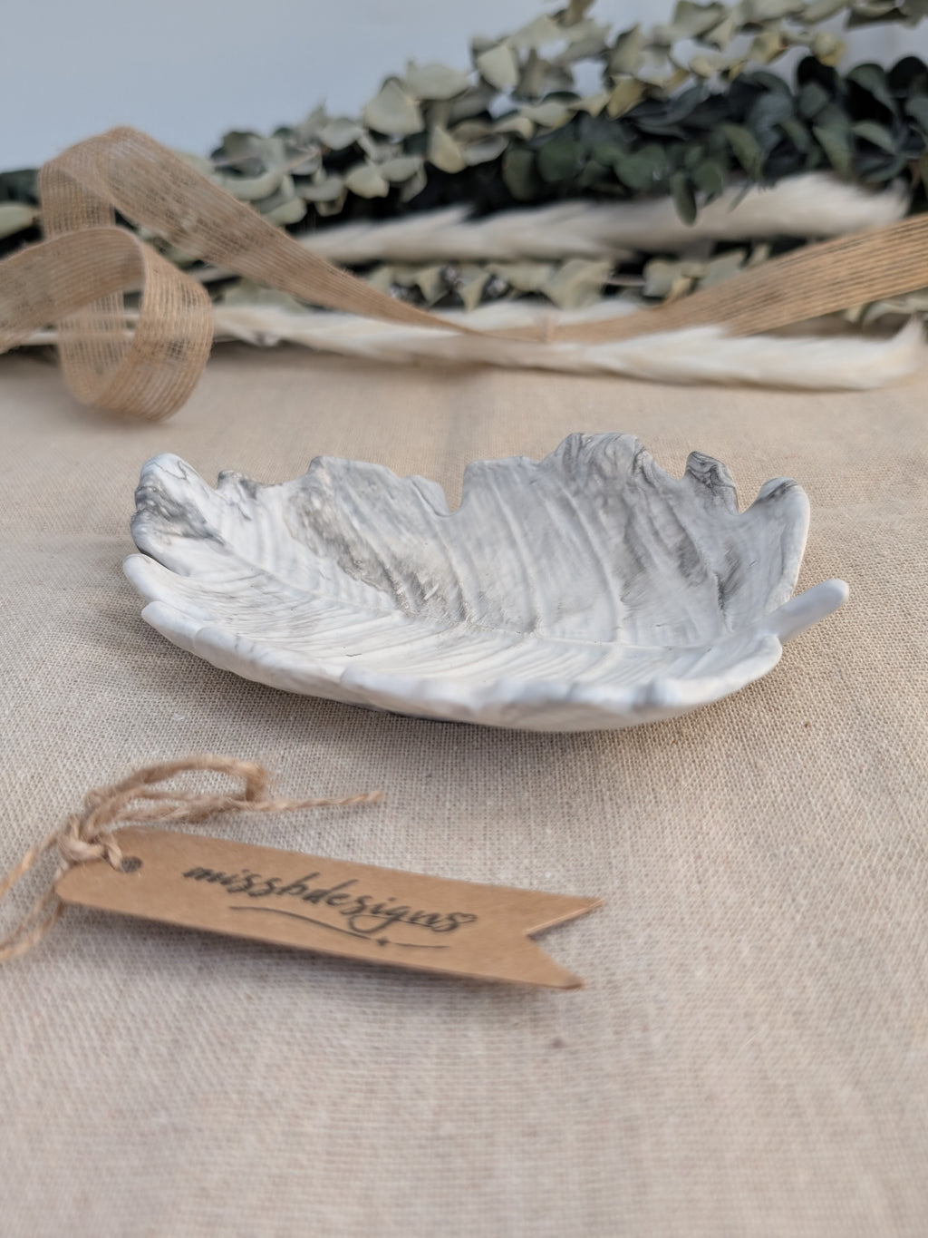 leaf shaped trinket tray made of eco resin jesmonite with a black grey marble effect handcrafted