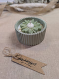 Natural sage green daisy candle in neutral green hand cast eco resin home decor pot scented with vanilla perfect gift