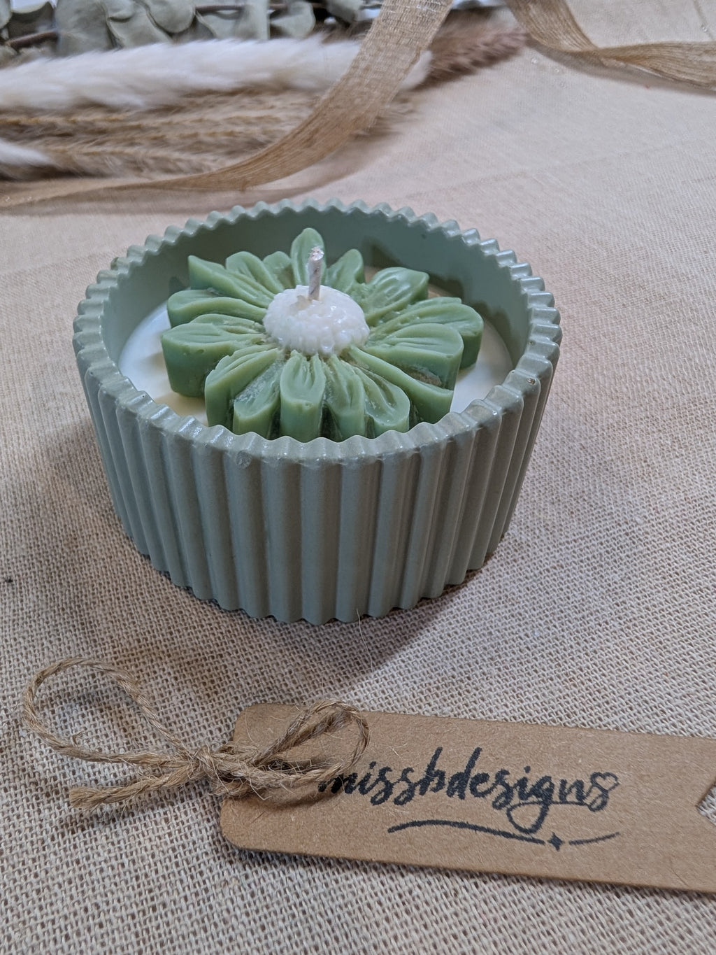 Natural sage green daisy candle in neutral green hand cast eco resin home decor pot scented with vanilla perfect gift