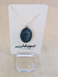 Necklace with a blue resin  pendant on silver chain handcrafted