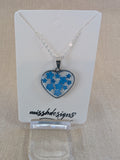 Heart shaped drop pendant with blue flowers set in resin on silver chain perfect handcrafted gift