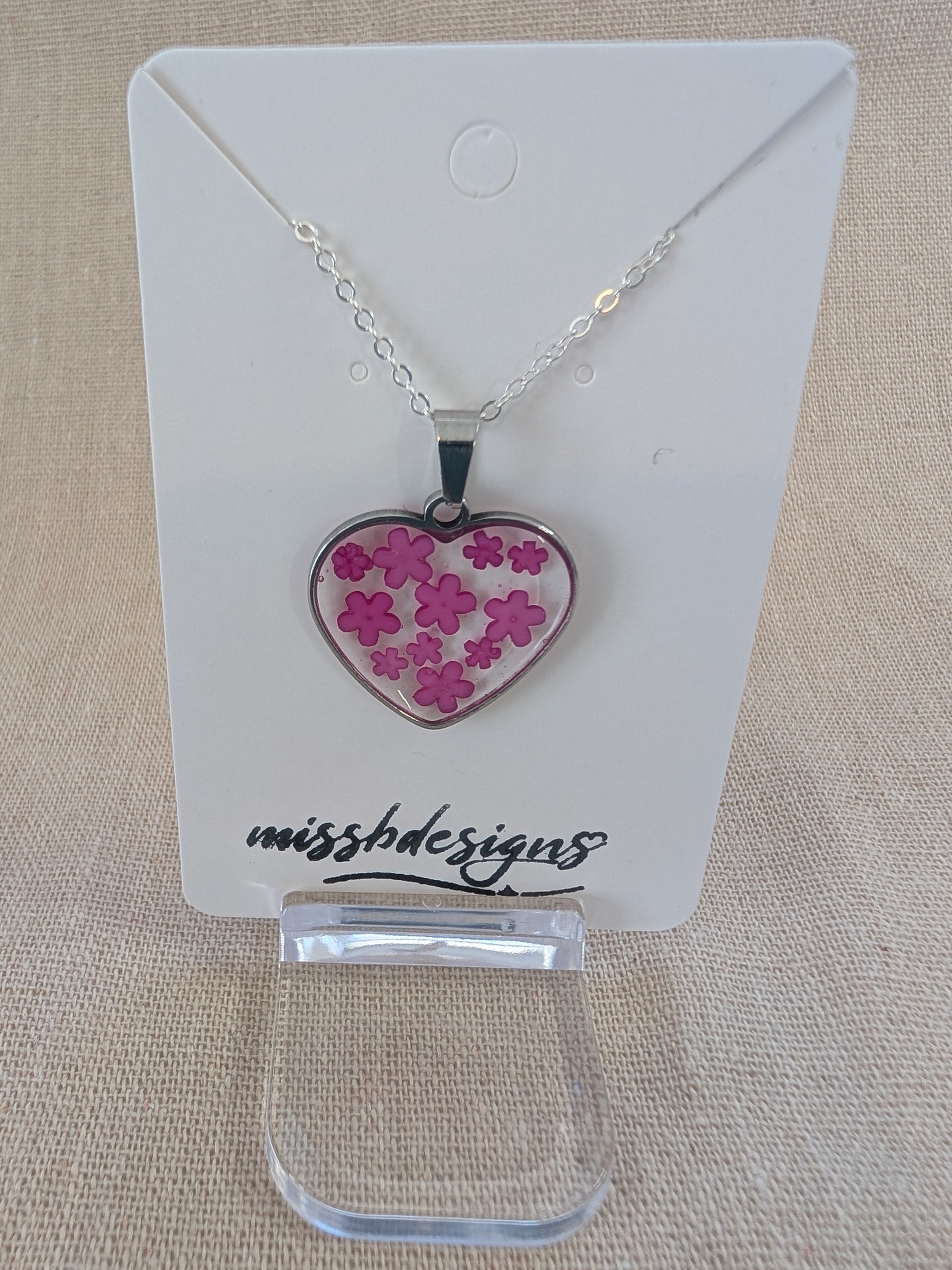 Heart shaped drop pendant with blue flowers set in resin on silver chain perfect handcrafted gift