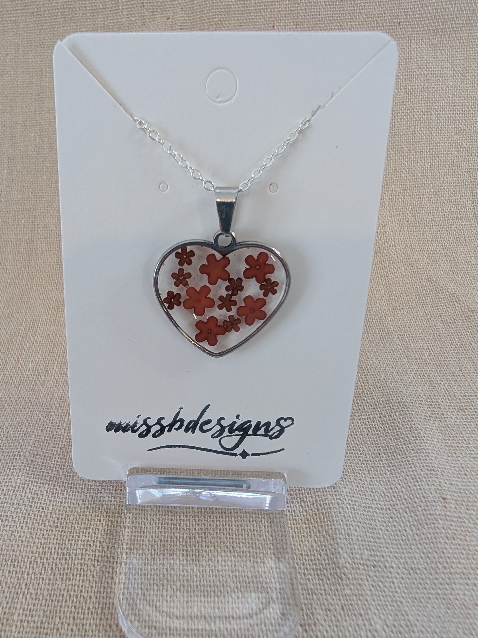 Heart shaped drop pendant with blue flowers set in resin on silver chain perfect handcrafted gift