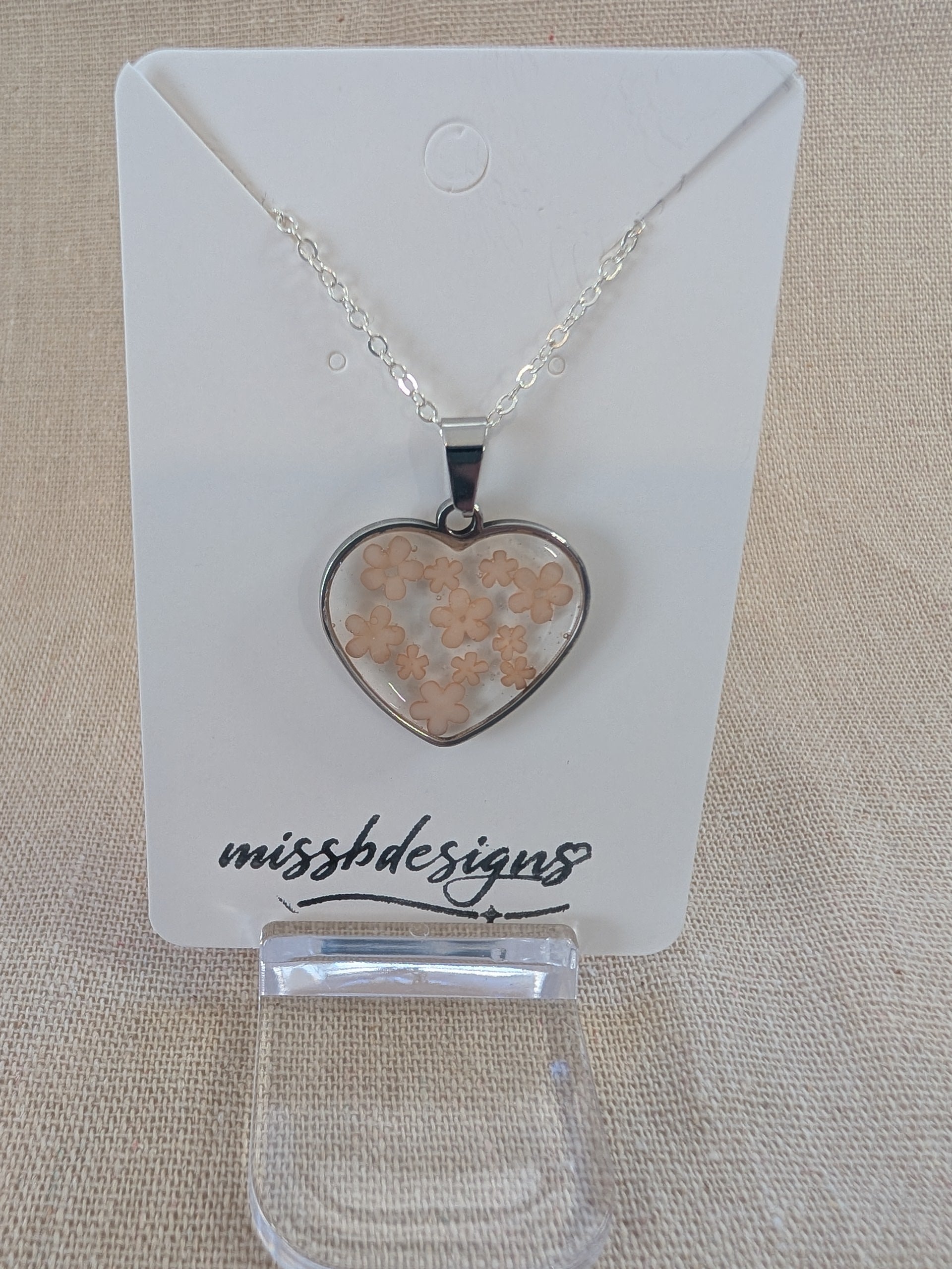 Heart shaped drop pendant with blue flowers set in resin on silver chain perfect handcrafted gift